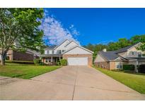 Charming two-story home with a brick and white facade and a well-manicured front yard at 3460 Village Park Sw Ln, Atlanta, GA 30331