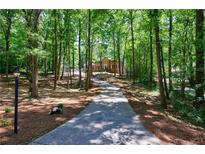 Long driveway winding through a wooded lot leading to a classic brick home at 1348 Timberland Se Dr, Marietta, GA 30067