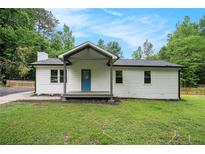 Charming renovated ranch with a blue front door, covered porch, new roof and a freshly painted exterior at 3952 Leisure Se Ct, Conyers, GA 30013