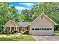 Charming single-Gathering home featuring a well-maintained lawn and attached two car garage at 3663 Homewood Trl, Powder Springs, GA 30127