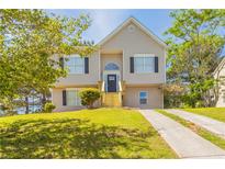 Charming two-story home with a well-maintained lawn and inviting front entrance at 4417 Roche St, Atlanta, GA 30349