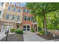 Charming townhome with well-manicured landscaping, front-entry garage, and inviting entrance at 2329 Marion Walk Se Dr # 5, Atlanta, GA 30339