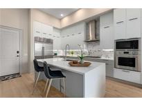Modern kitchen features white cabinets, stainless steel appliances, and a quartz countertop island at 40 12Th Ne St # 803, Atlanta, GA 30309
