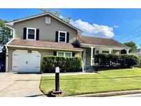 Charming home with a well-maintained lawn, an attached garage, and a cozy front porch at 6325 Stablewood Way, Lithonia, GA 30058