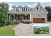 Charming two-story home with a landscaped front yard and a view of Lake Lanier at 7540 Shadburn Ferry Rd, Cumming, GA 30041