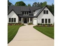 Beautifully landscaped home featuring a bright yard, dark framed windows, double-door entry, and neutral-toned driveway at 101 Deer Canyon Dr, Auburn, GA 30011