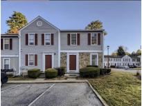 Charming townhouse featuring stone accents, red shutters, and well-maintained landscaping at 3414 Bayshore Dr, Atlanta, GA 30340