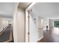 Inviting entryway featuring hardwood floors and a view into the living area with a fireplace at 1312 Pine Heights Ne Dr, Atlanta, GA 30324