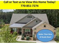 Charming exterior of a well maintained home with a manicured lawn at 438 Southland Cir, Canton, GA 30115