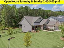 Beautiful single-Gathering home with manicured lawn and lush landscaping at 438 Southland Cir, Canton, GA 30115