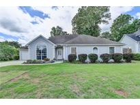 Charming one-story home with large arched windows and well-maintained landscaping at 500 Birch Forest Ln, Alpharetta, GA 30005