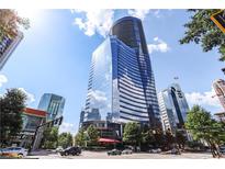 Modern high-rise building featuring sleek glass facade and prime city location at 3344 Peachtree Rd # 3505, Atlanta, GA 30326