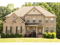 Charming brick home with well-maintained landscaping and inviting front porch at 305 Anise Ct, Mcdonough, GA 30252