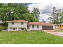 Charming two-story home with a brick exterior, well-manicured lawn, and a two-car garage at 3275 Clifton Church Se Rd, Atlanta, GA 30316