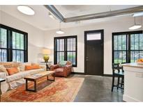 Bright living room featuring large windows, a comfortable couch, and a colorful area rug at 791 Wylie Se St # 807, Atlanta, GA 30316