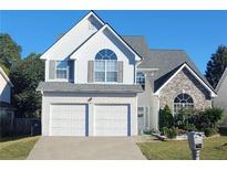 Charming two-story home with a two-car garage, stone accents, and well-maintained landscaping at 245 Vaness Dr, Mcdonough, GA 30253