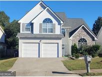 Charming two-story home with a two-car garage and well-manicured lawn at 245 Vaness Dr, Mcdonough, GA 30253