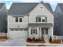 Charming two-story home featuring a two-car garage and covered porch at 1006 Fendley St, Woodstock, GA 30188