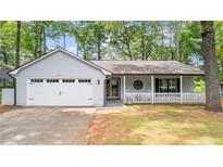Charming single-story home featuring a lovely front porch, a two-car garage, and a well-maintained lawn at 4771 Pinefield Nw Dr, Acworth, GA 30102