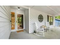 Inviting front porch with rocking chairs, decor, and a welcoming entrance at 4771 Pinefield Nw Dr, Acworth, GA 30102