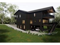 Modern three-story home with a two-car garage, manicured lawn, and multi-level balconies at 984 Sycamore Dr, Decatur, GA 30030