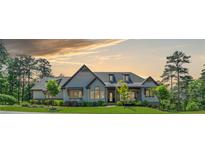 Stunning single-story home with beautiful architecture and mature landscaping under a picturesque sky at 23 Sunset Se Rdg, Cartersville, GA 30121