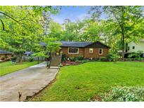 Charming brick home featuring a well-maintained front yard and inviting entrance staircase at 2511 Oak Ave, Tucker, GA 30084