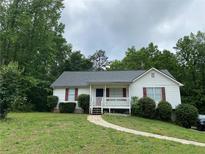 Charming single-story home with a well-maintained lawn and inviting front porch at 50 Glenmore Dr, Kingston, GA 30145