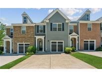 Charming townhome with a well-manicured lawn and attached garage at 5221 Sherwood Way, Cumming, GA 30040