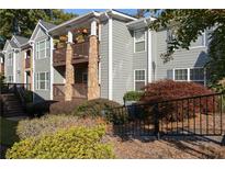 View of the condo's exterior showcasing the building's architectural details and landscaping at 1102 Madison Ln # 1102, Smyrna, GA 30080
