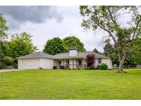 Charming home with a well-manicured lawn, mature trees, and an attached two-car garage at 7925 Silversmith Dr, Cumming, GA 30028
