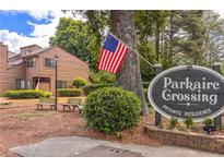 Parkaire Crossing community sign in a private residence with an American flag in the yard at 907 Parkaire Xing, Marietta, GA 30068