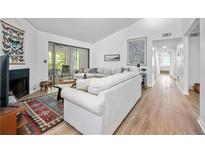 Bright living room features a fireplace, sliding glass doors, and modern decor at 907 Parkaire Xing, Marietta, GA 30068