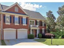 Charming brick home with a two-car garage, black shutters, and manicured landscaping at 475 Vinings Estates Se Dr # A03, Smyrna, GA 30126