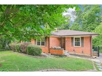 Charming brick home with well-manicured lawn and mature trees at 845 Stratford Rd, Avondale Estates, GA 30002