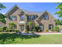Stately brick home featuring a landscaped front yard and a welcoming entrance at 4765 Smokestone Dr, Douglasville, GA 30135