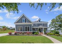 Charming two-story home with a landscaped front yard, inviting entryway and classic architectural details at 4035 Pinebrook Cir, Cumming, GA 30028