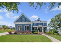 Beautiful two-story blue house with landscaped front yard and inviting entryway, offering charm and curb appeal at 4035 Pinebrook Cir, Cumming, GA 30028