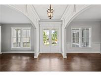 Inviting foyer with hardwood floors, classic millwork, arched openings, and bright, natural light at 4035 Pinebrook Cir, Cumming, GA 30028