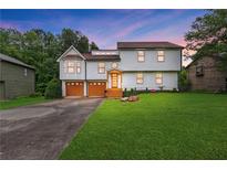 Charming two-story home with a well-manicured lawn, two car garage and covered entry at 1105 Sallete Ct, Marietta, GA 30066