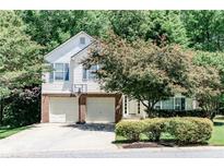 Charming two-story home featuring a two-car garage and well-maintained landscaping in a lush, green neighborhood at 2204 Dresden Nw Grn, Kennesaw, GA 30144