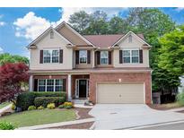 Charming two-story home with brick accents, a well-manicured lawn, and a two-car garage at 139 Lake Reserve Way, Canton, GA 30115