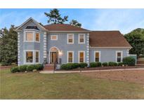 Charming two-story home boasts a well-manicured lawn and inviting curb appeal in a lovely neighborhood at 771 James Cir, Lawrenceville, GA 30046