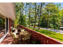 A brick patio features outdoor furniture and provides a view of the lush green lawn and surrounding trees at 2279 Parkview Cir, College Park, GA 30337