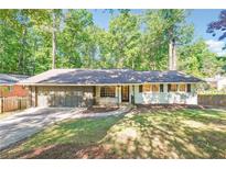 Charming ranch-style home with a well-maintained front yard and attached two car garage at 3708 Canadian Way, Tucker, GA 30084
