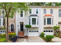 Attractive townhome showcases a stylish facade, well-maintained landscaping, and attached garage at 3910 Meeting St, Duluth, GA 30096