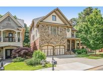 Beautiful stone-front home with attached two-car garage and well-manicured lawn at 2672 Brickell Square, Atlanta, GA 30341