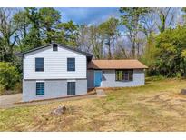 Charming two-story home featuring a blue front door and a well-maintained front yard at 6684 Heathrow Ln, Stone Mountain, GA 30087