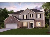 Beautiful two-story home featuring a brick and siding facade, manicured lawn, and a two-car garage at 720 Hedwig Dr, Mcdonough, GA 30252