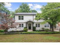 Charming two-story home with white siding, black trim, and well-manicured landscaping at 146 Mount Paran Ne Rd, Atlanta, GA 30342